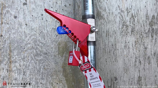 Red ball valve lockout attached on a valve handle with LOTO lock and tag