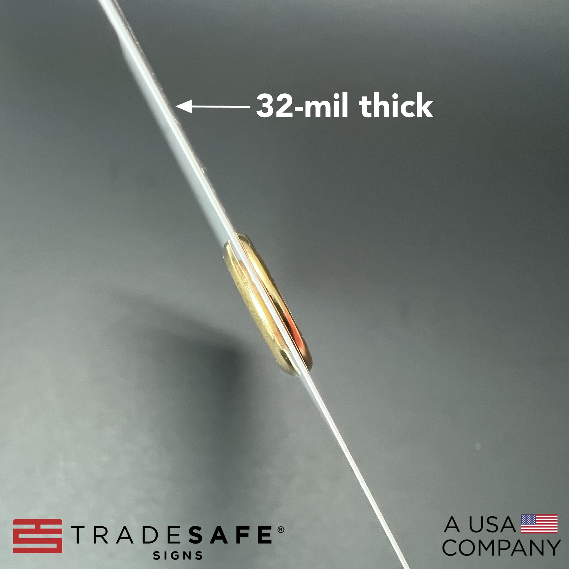 macro shot of bilingual tag showing its thickness; 32-mil thick