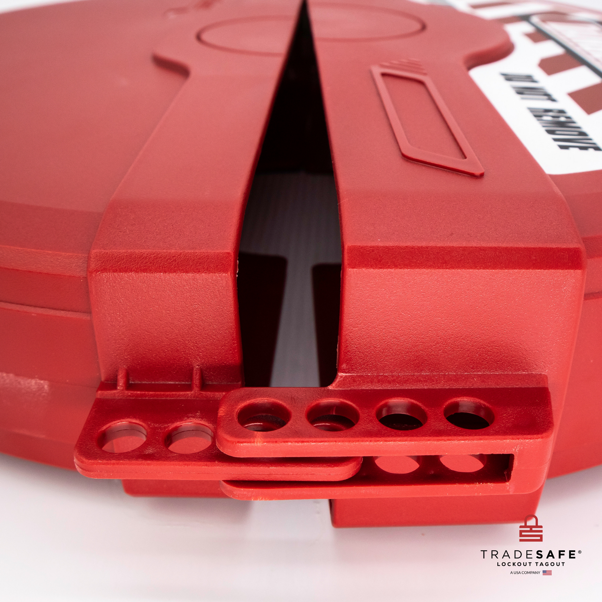 close-up view of the four padlock holes of a slightly opened red gate valve lockout