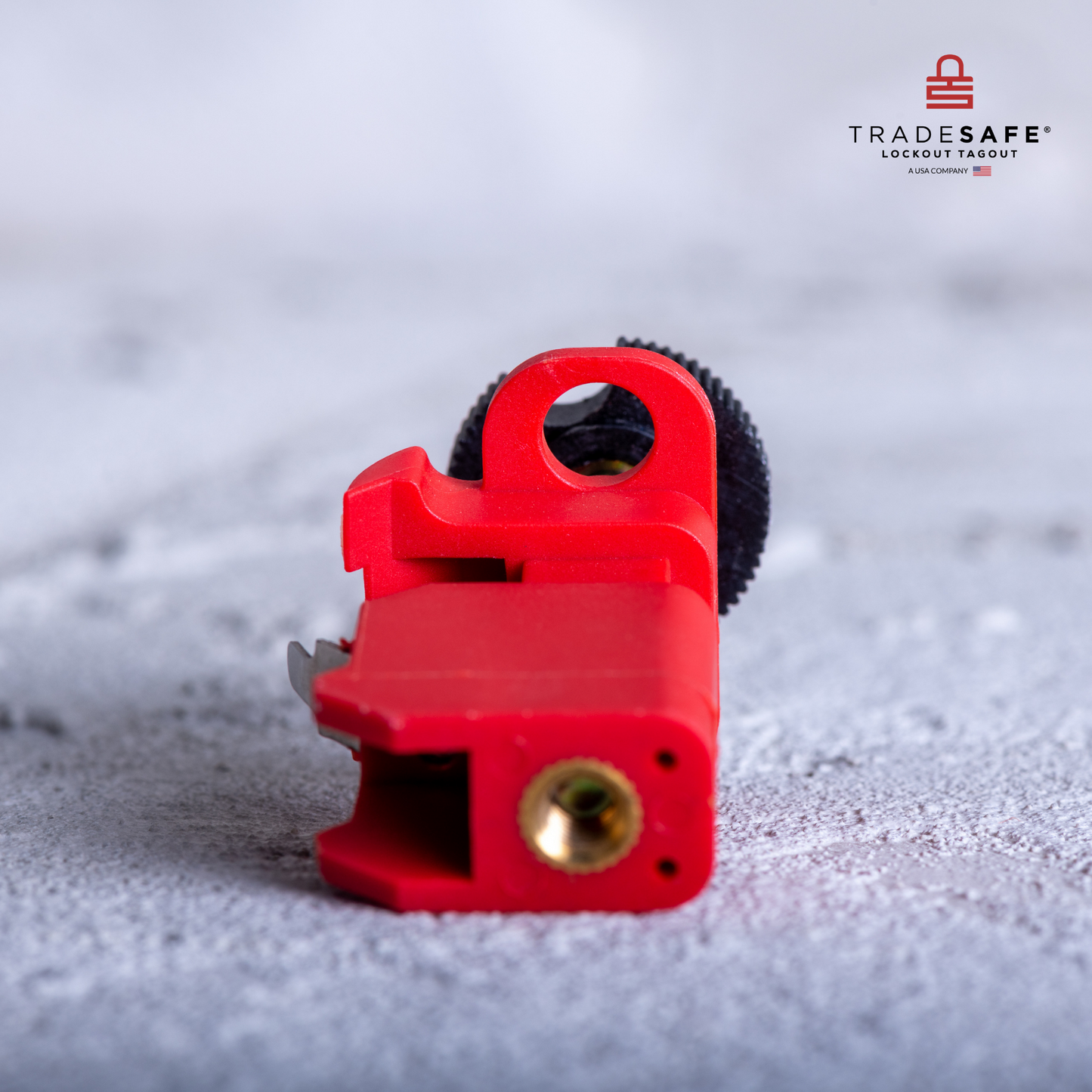eye-level view of a tie bar miniature circuit breaker lockout lying down in a concrete floor showing the bottom part