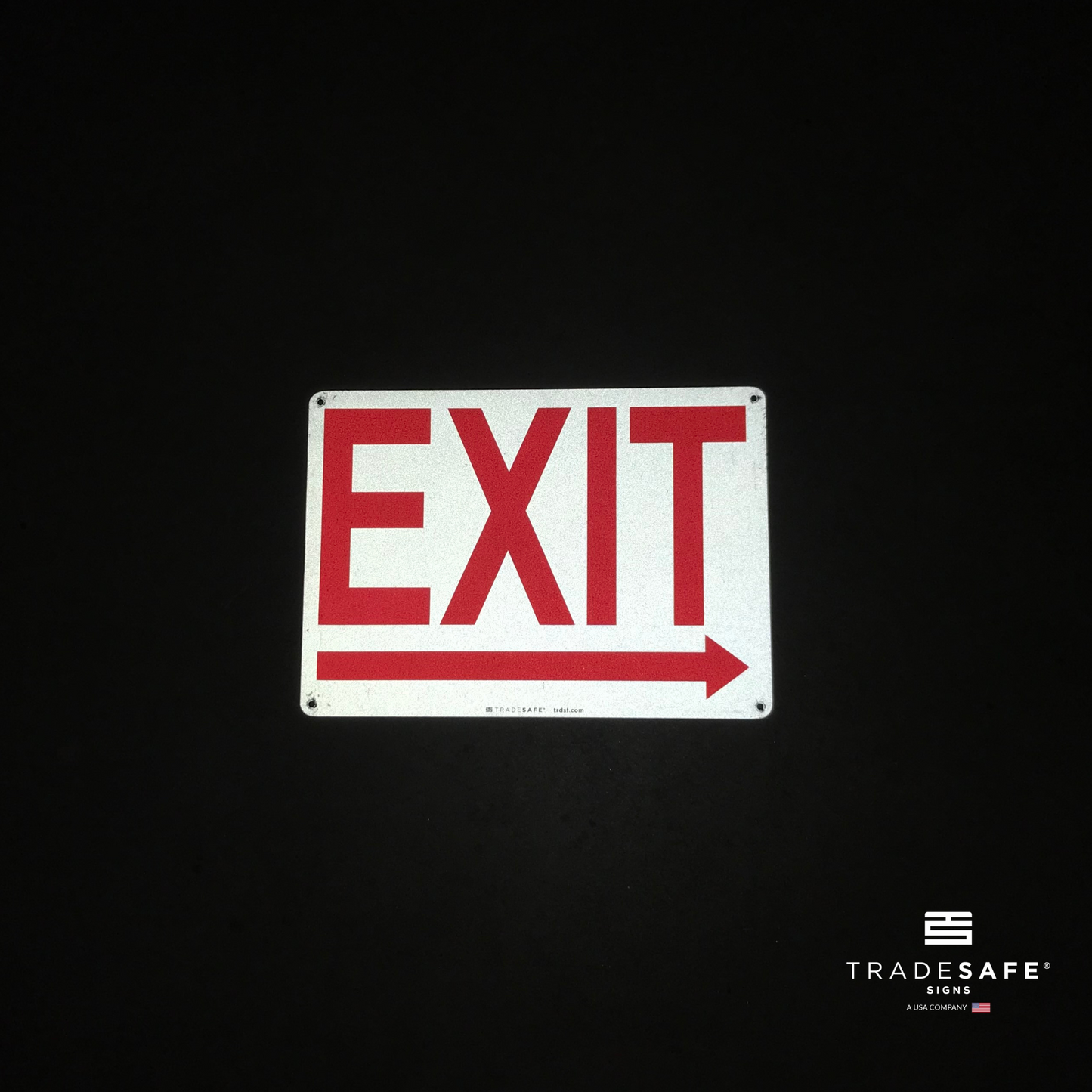 reflective attribute of exit sign with right arrow on black background