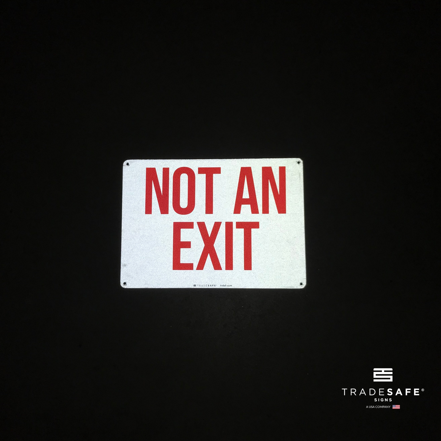 reflective attribute of not an exit sign on black background