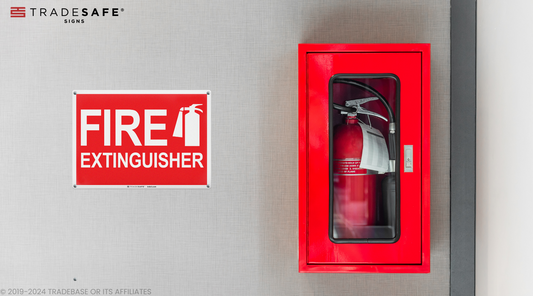 fire extinguisher sign beside an encased fire extinguisher