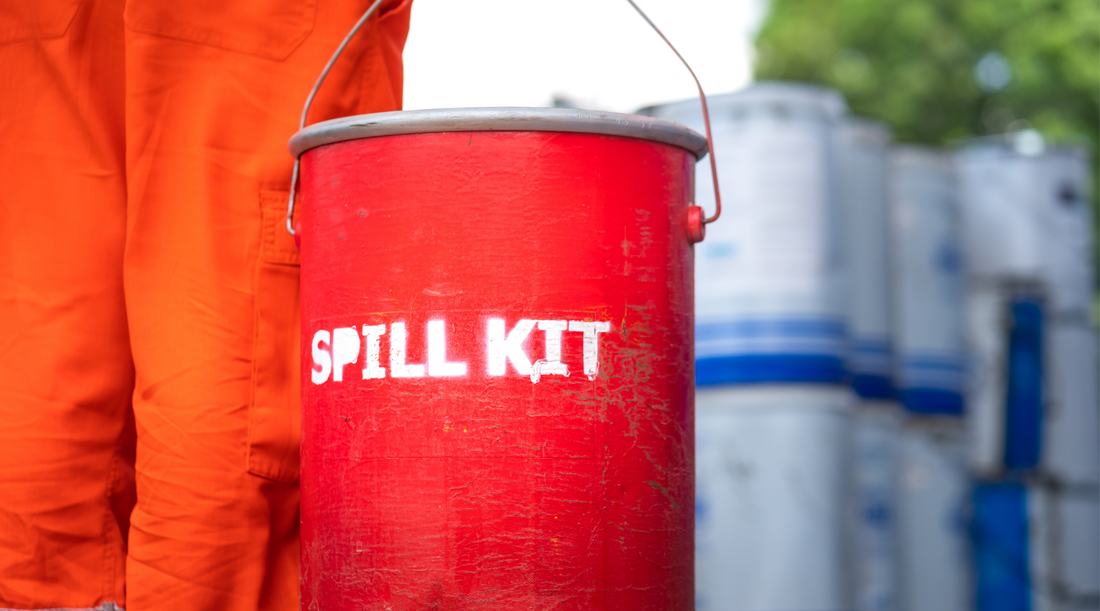 red spill kit carried by a worker
