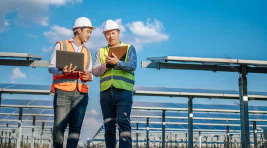 two industrial workers with clipboards