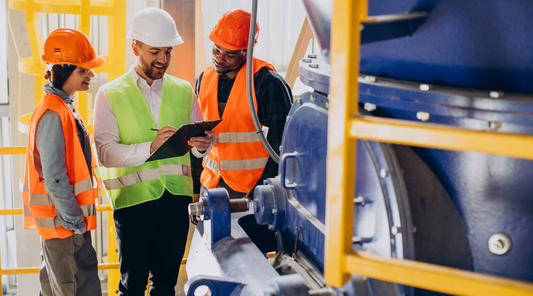 Industrial workers looking at a clipboard