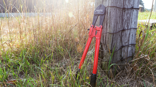 a bolt cutter against a post