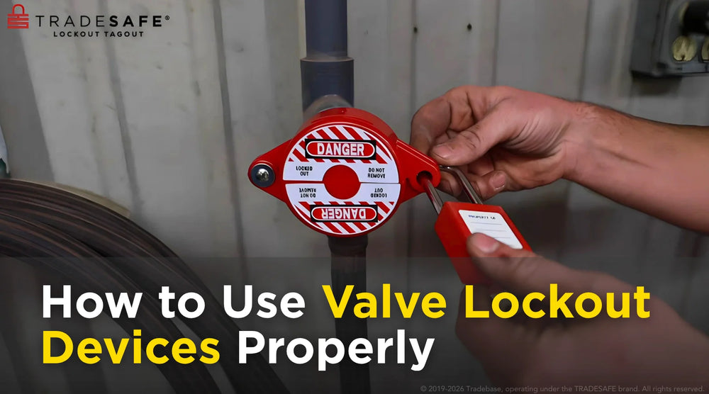 Technician applying a valve lockout device and safety padlock during hazardous energy isolation and lockout tagout maintenance procedure