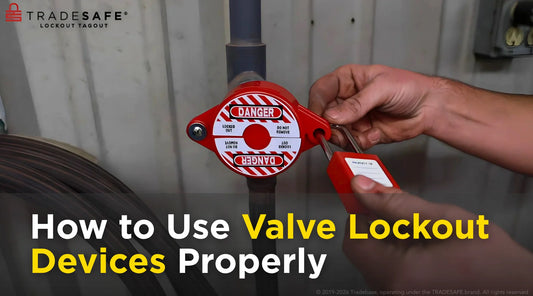 Technician applying a valve lockout device and safety padlock during hazardous energy isolation and lockout tagout maintenance procedure