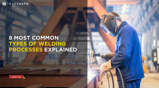 welder in protective gear working on a metal beam