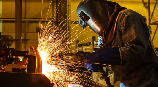 Welder wearing flame-resistant clothing