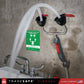 emergency eye wash station with water flowing, mounted on a concrete wall