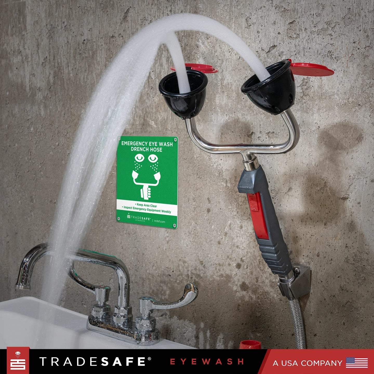 emergency eye wash station with water flowing, mounted on a concrete wall