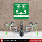emergency eye wash station attached to faucet with green emergency sign