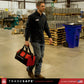 man carrying portable lockout kit bag in an industrial setting