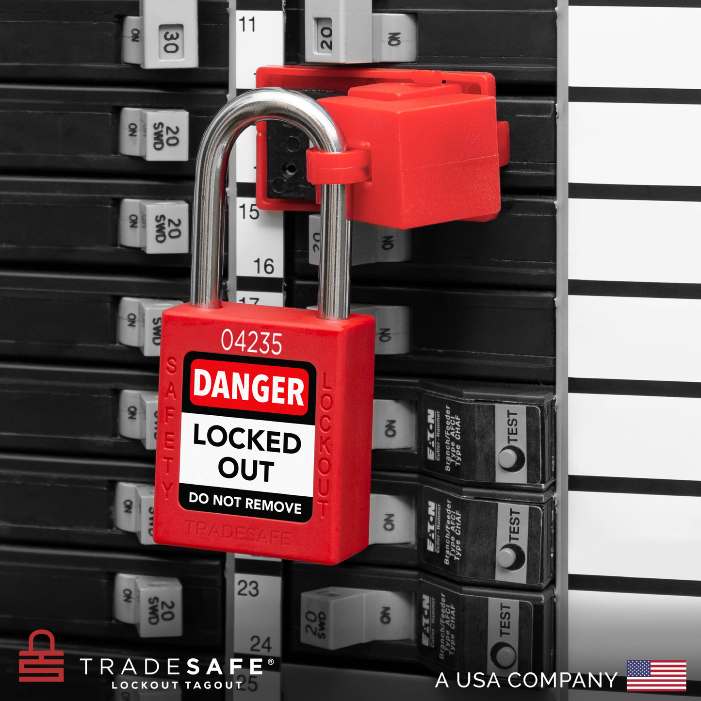 a red loto padlock in use along with a clamp-on circuit breaker lock