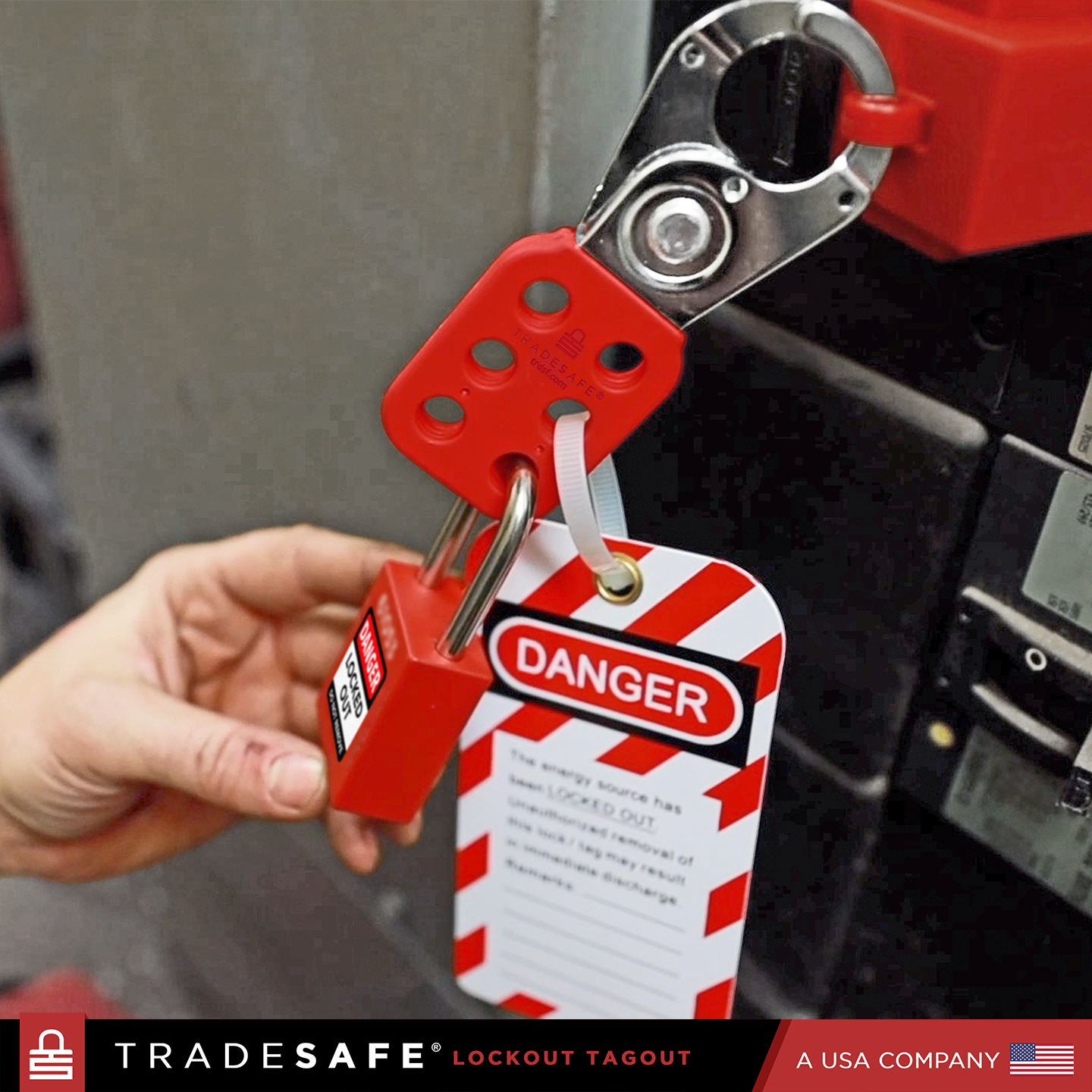 stainless steel hasp securing a circuit breaker lock with a padlock, featuring a LOTO tag for safety