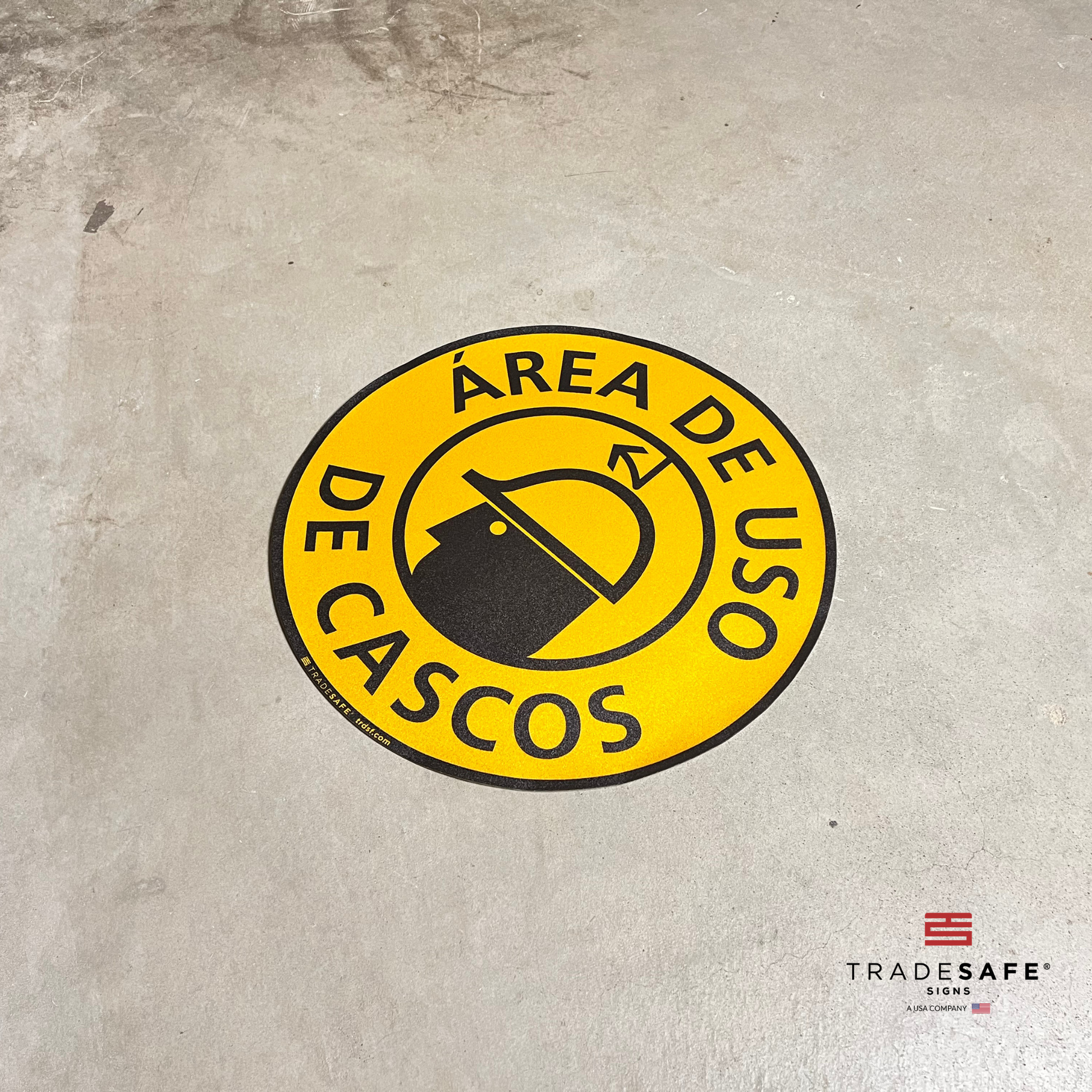 spanish version of "hard hat area" sign on floor