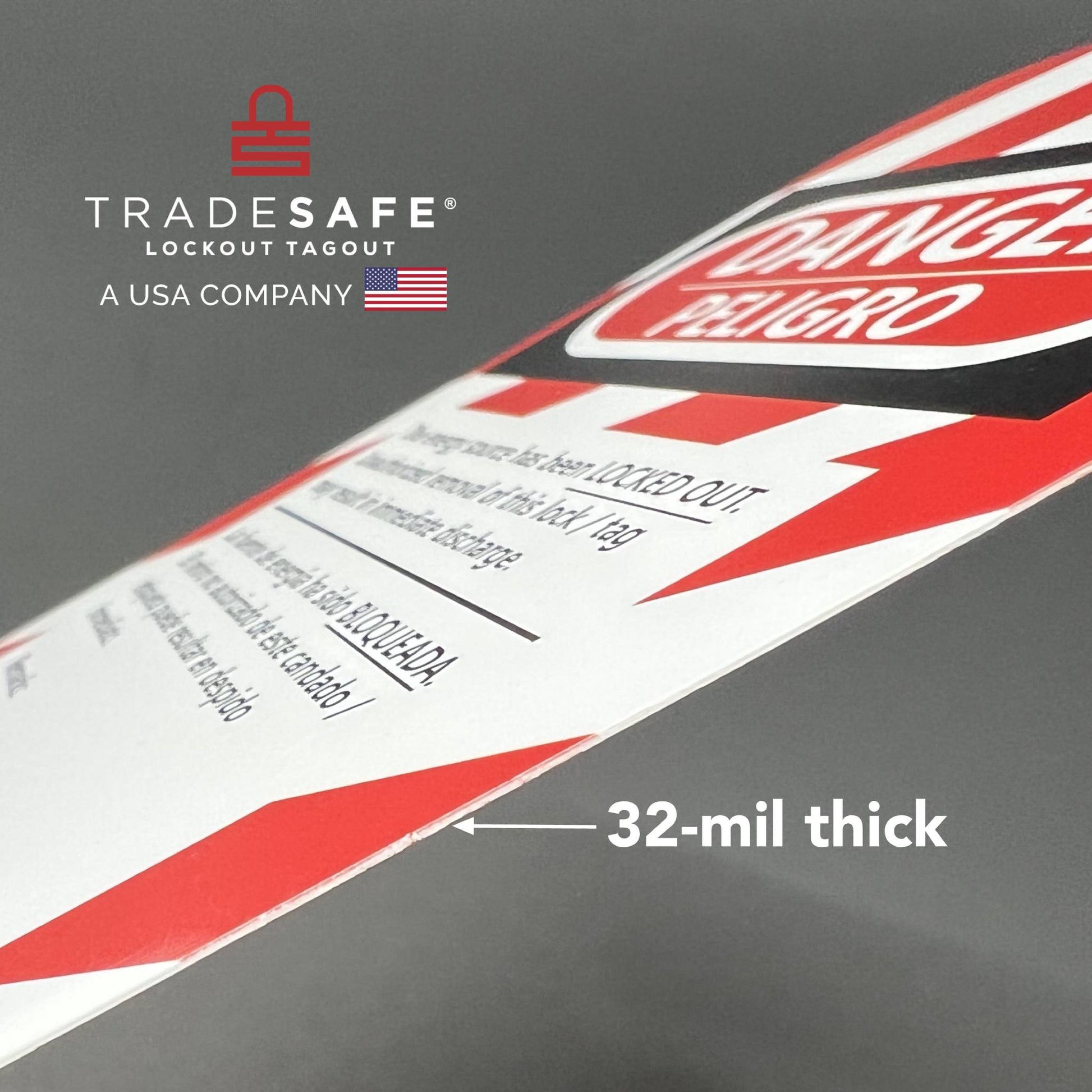 macro shot of slanted loto bilingual tag showing its thickness; 32-mil thick