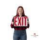 a person holding the exit sign