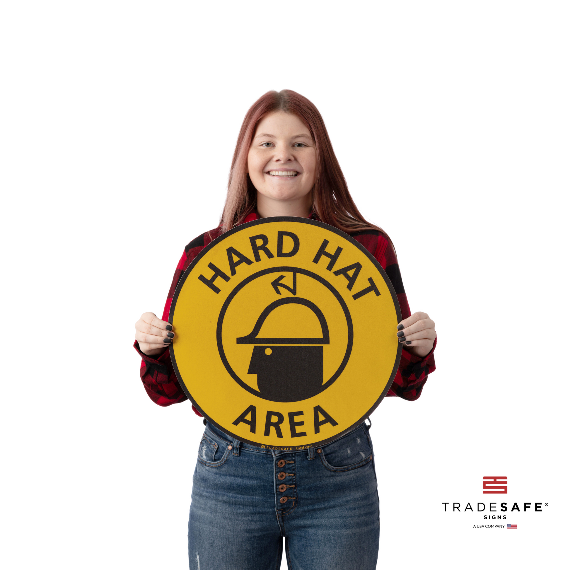 a person holding the hard hat area sign