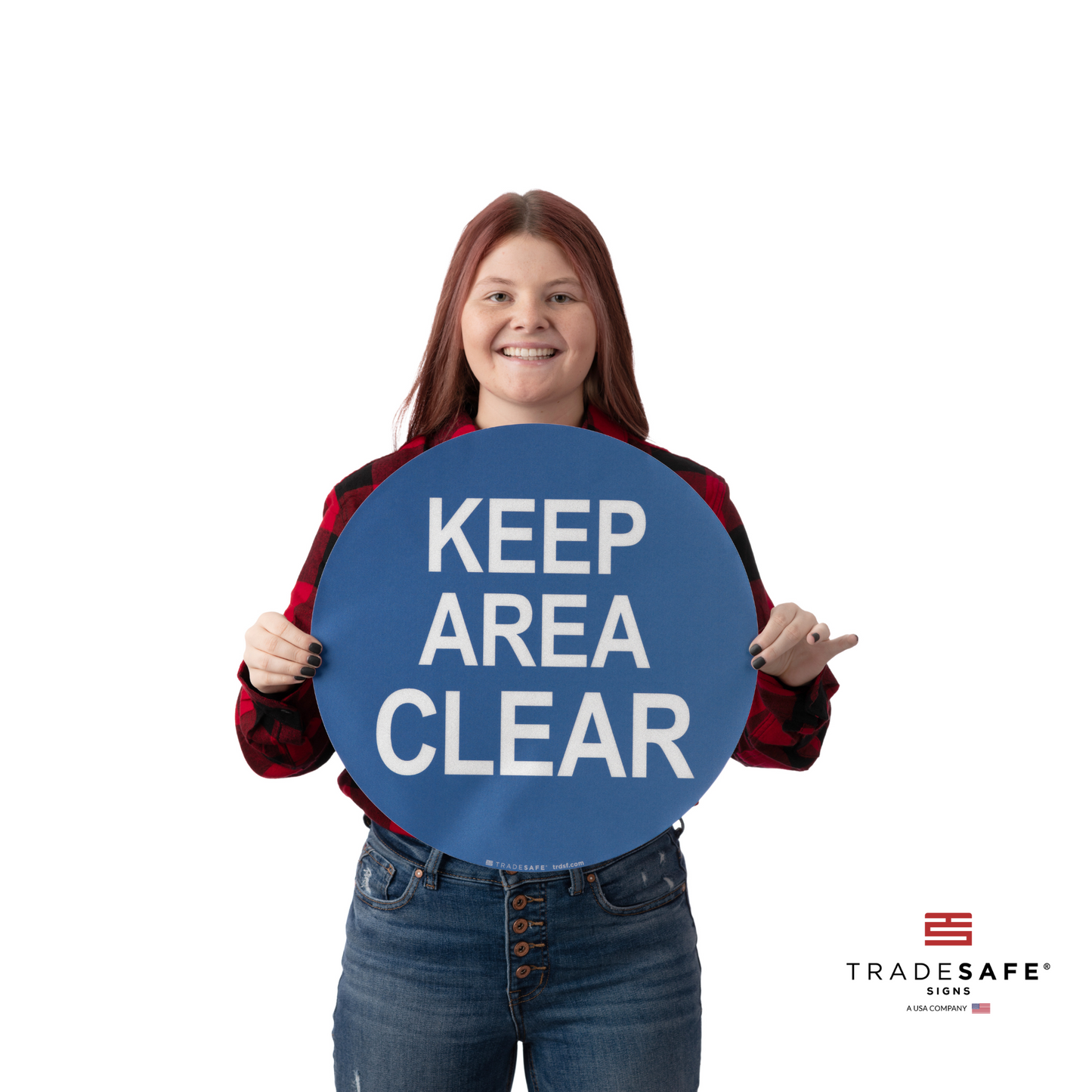 a person holding an adhesive vinyl sign with the text "keep area clear"