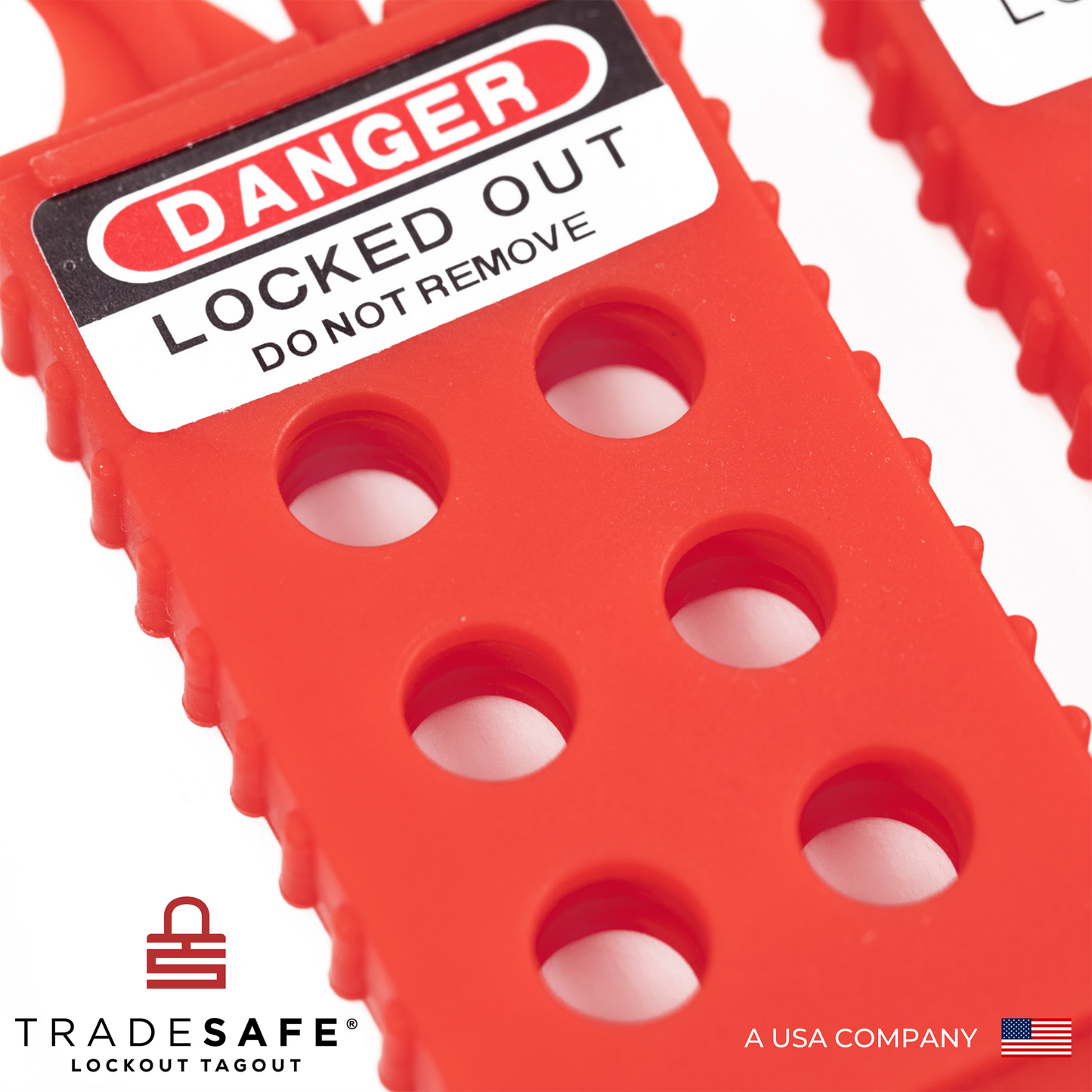 extreme close up view of the body of the plastic red lockout tagout hasp featuring the 6 holes in its body