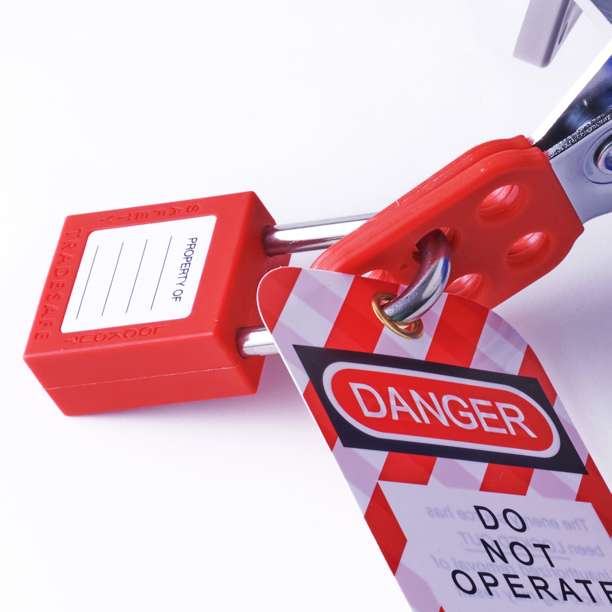 red lockout padlock attached to a hasp and safety tag