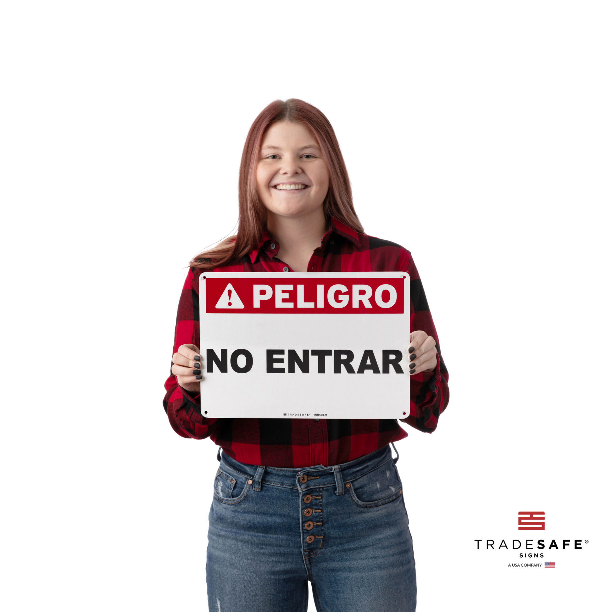 a person holding "peligro no entrar" sign