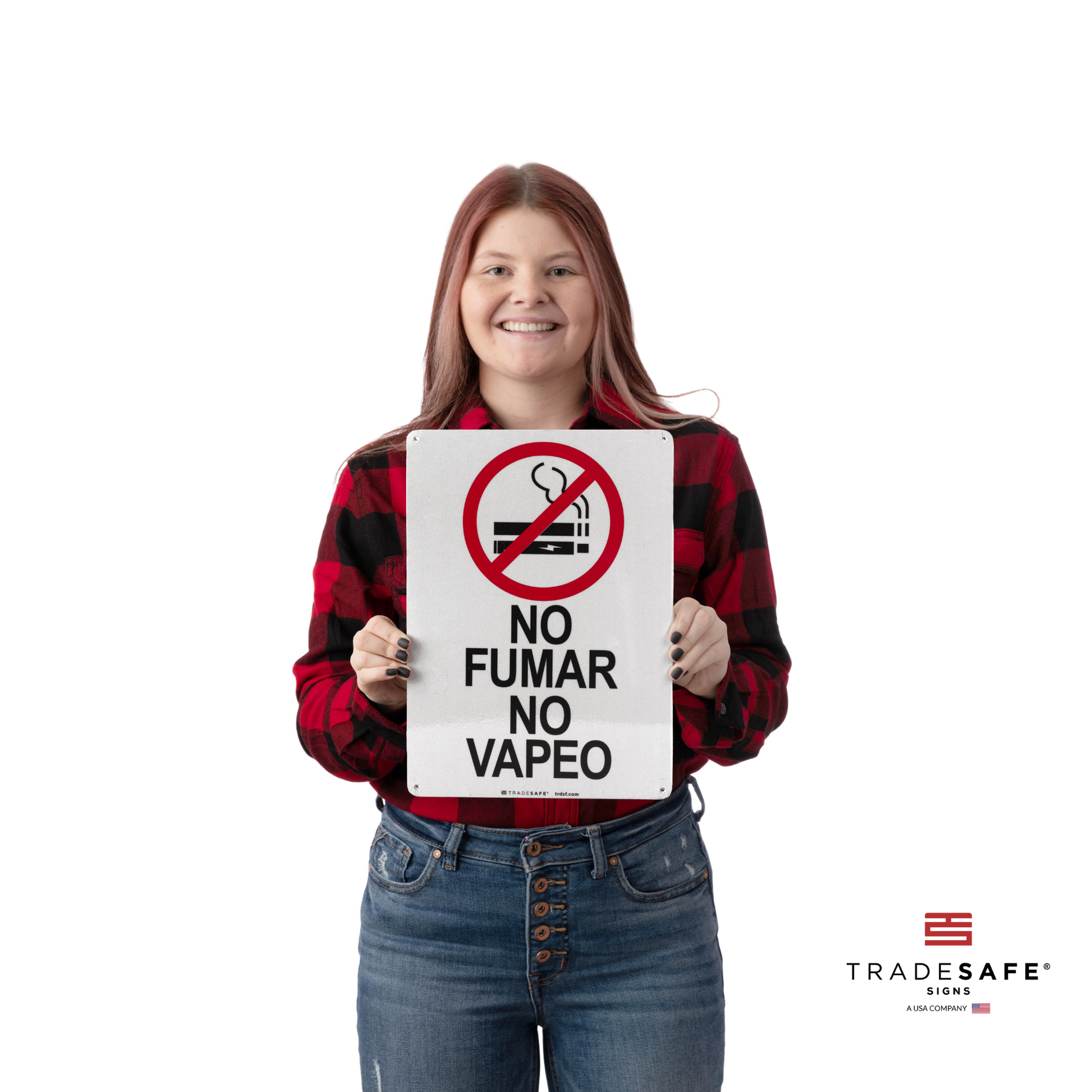 a person holding the no smoking no vaping sign in spanish