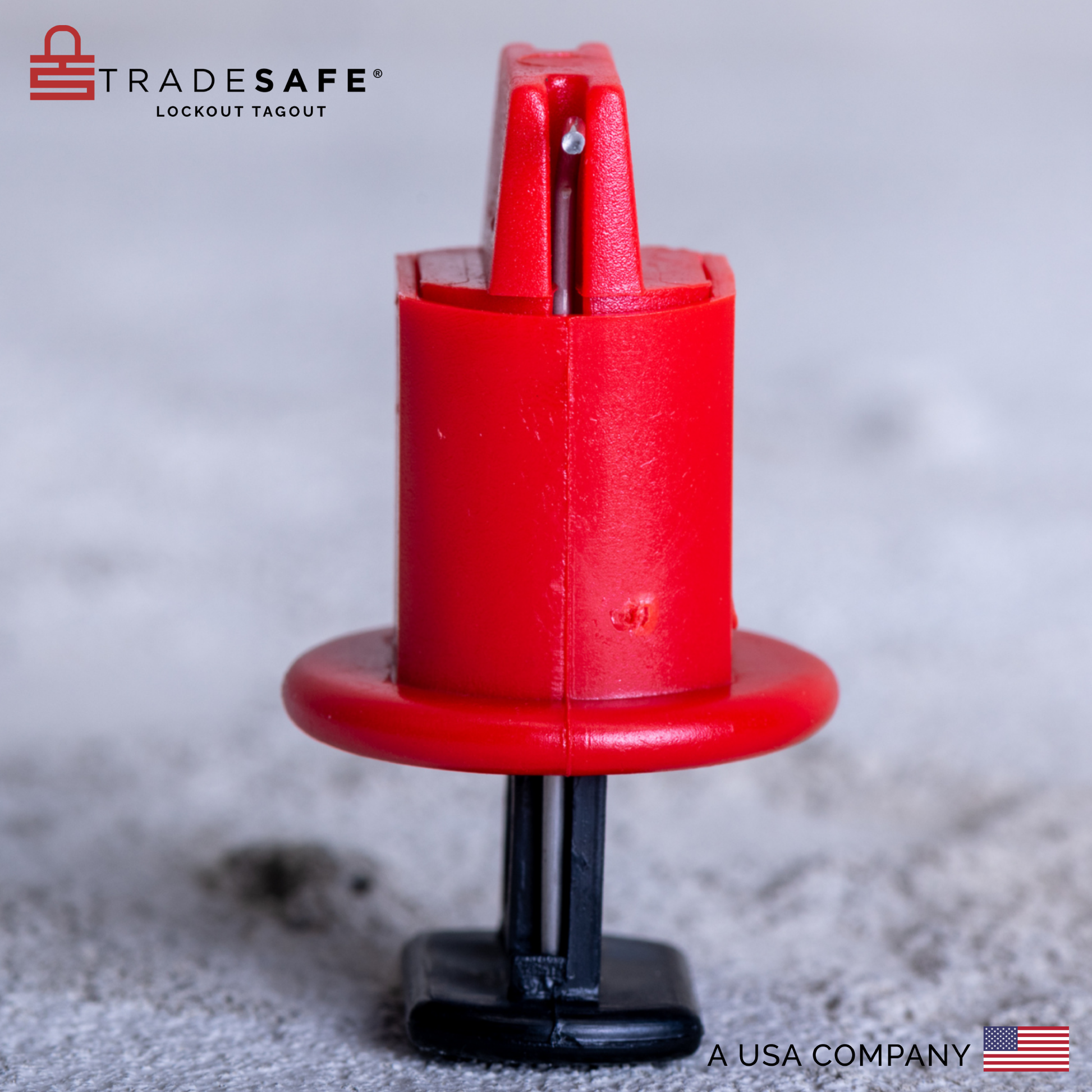 eye-level side view of a pin out wide miniature circuit breaker lockout with a concrete wall and floor background