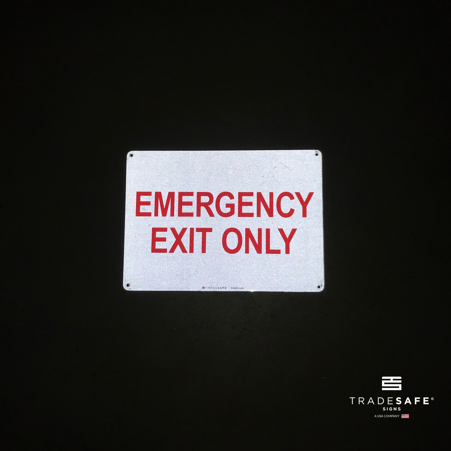 reflective attribute of emergency exit only sign on black background