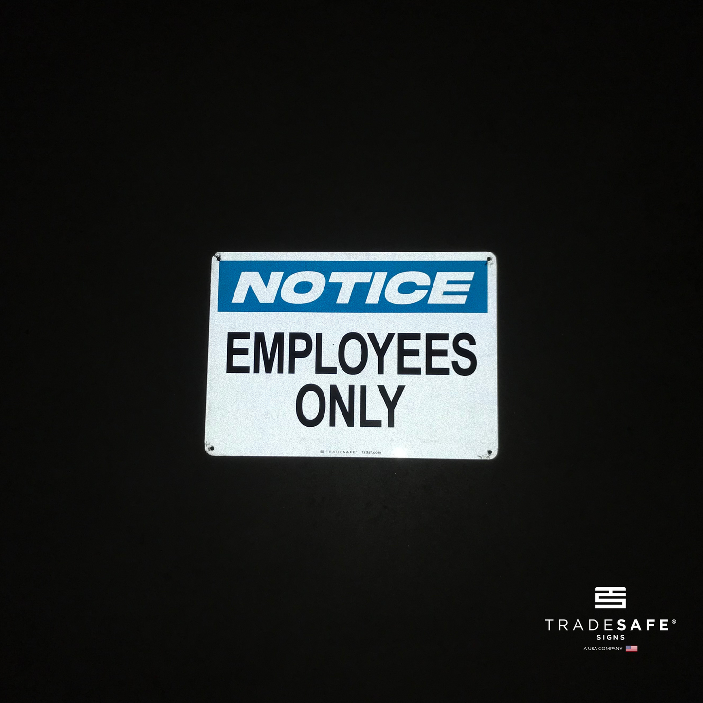 reflective attribute of employees only sign on black background