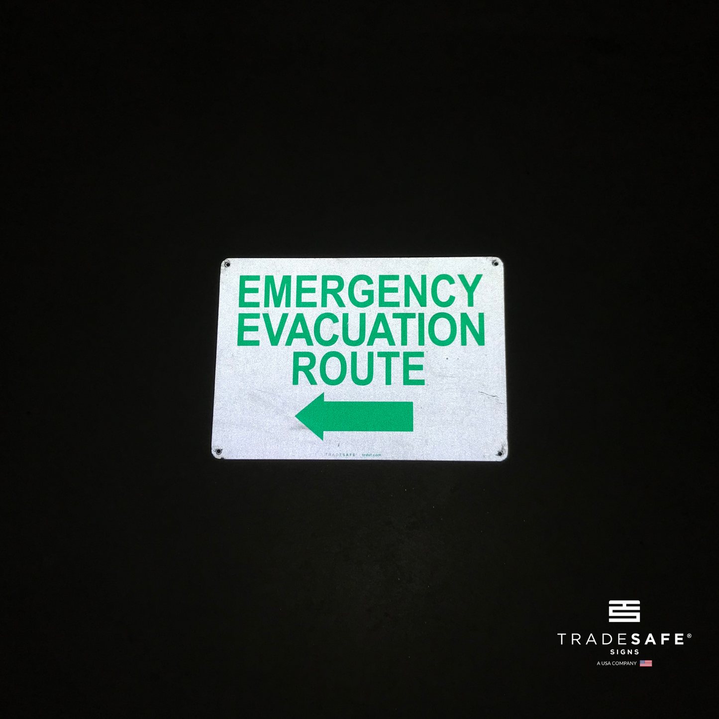 reflective attribute of evacuation sign on black background