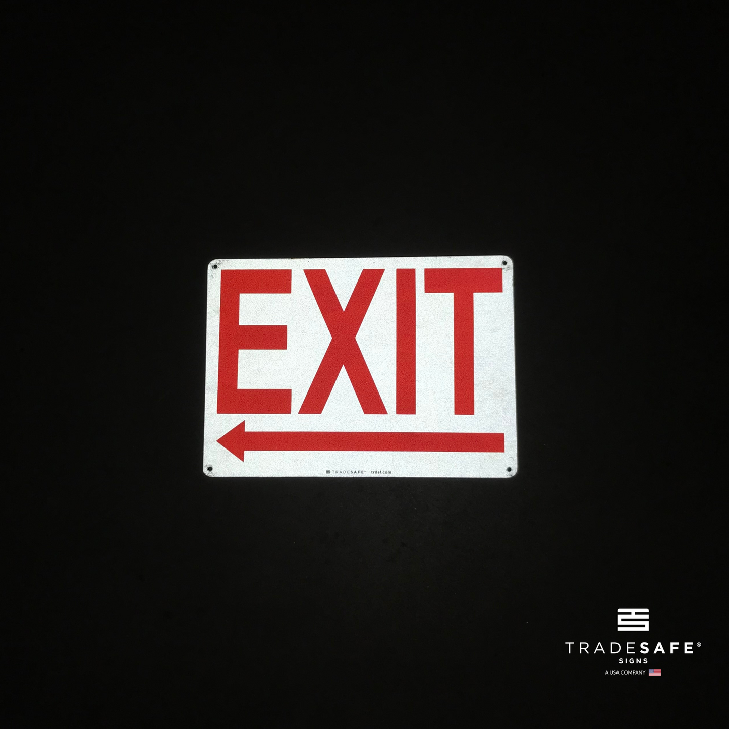 reflective attribute of exit sign with left arrow on black background