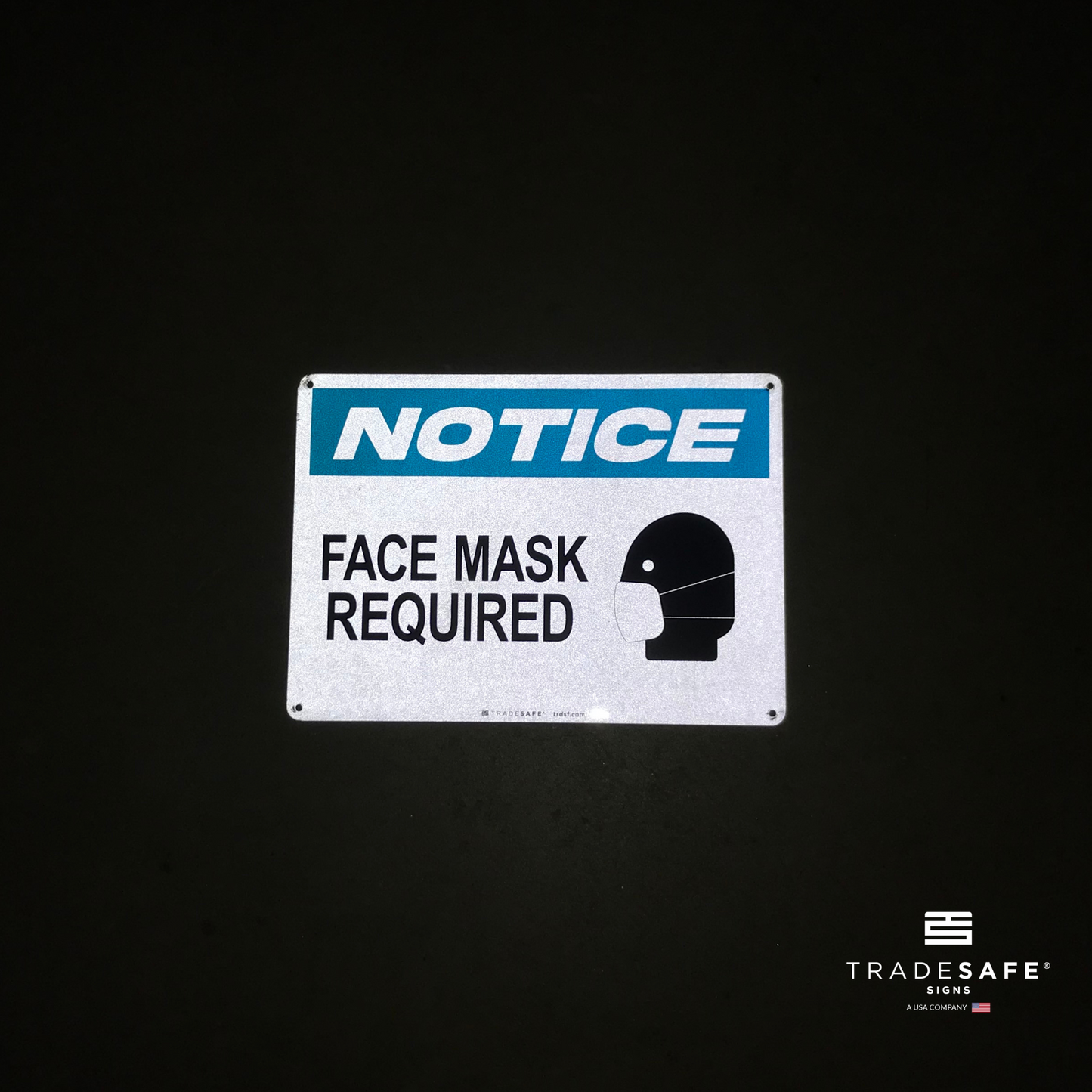 reflective attribute of face mask required sign on black background