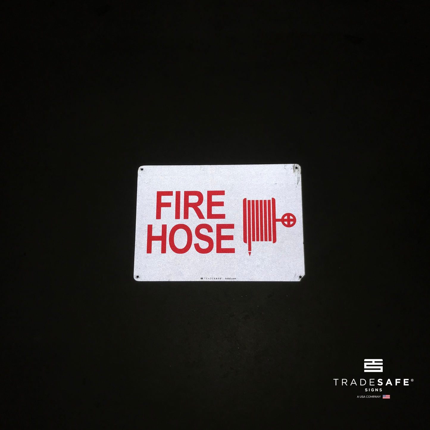 reflective attribute of fire hose sign on black background