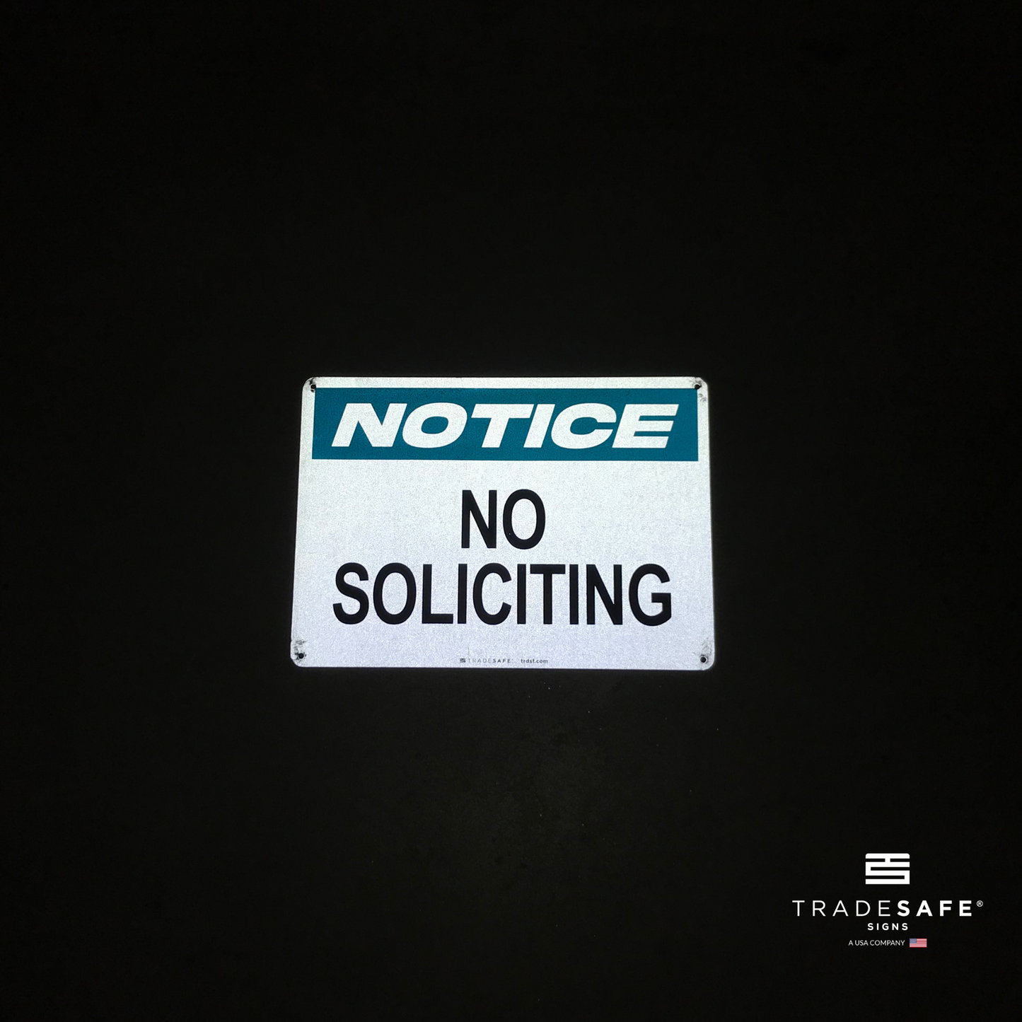 reflective attribute of no soliciting sign on black background