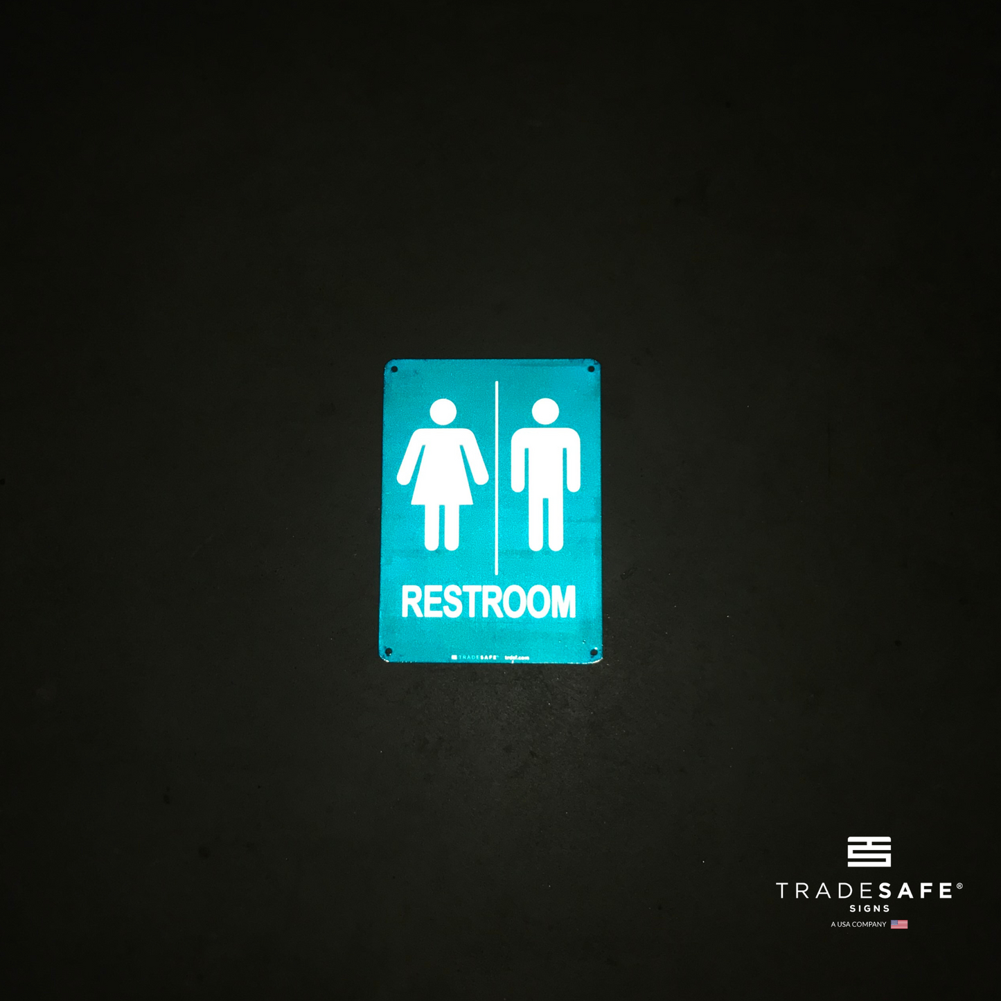 reflective attribute of unisex restroom sign on black background