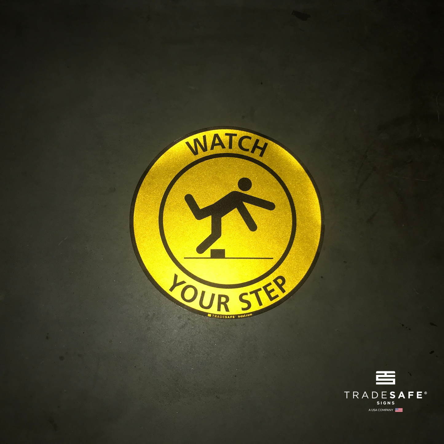 reflective attribute of adhesive vinyl "watch your step" sign on black background
