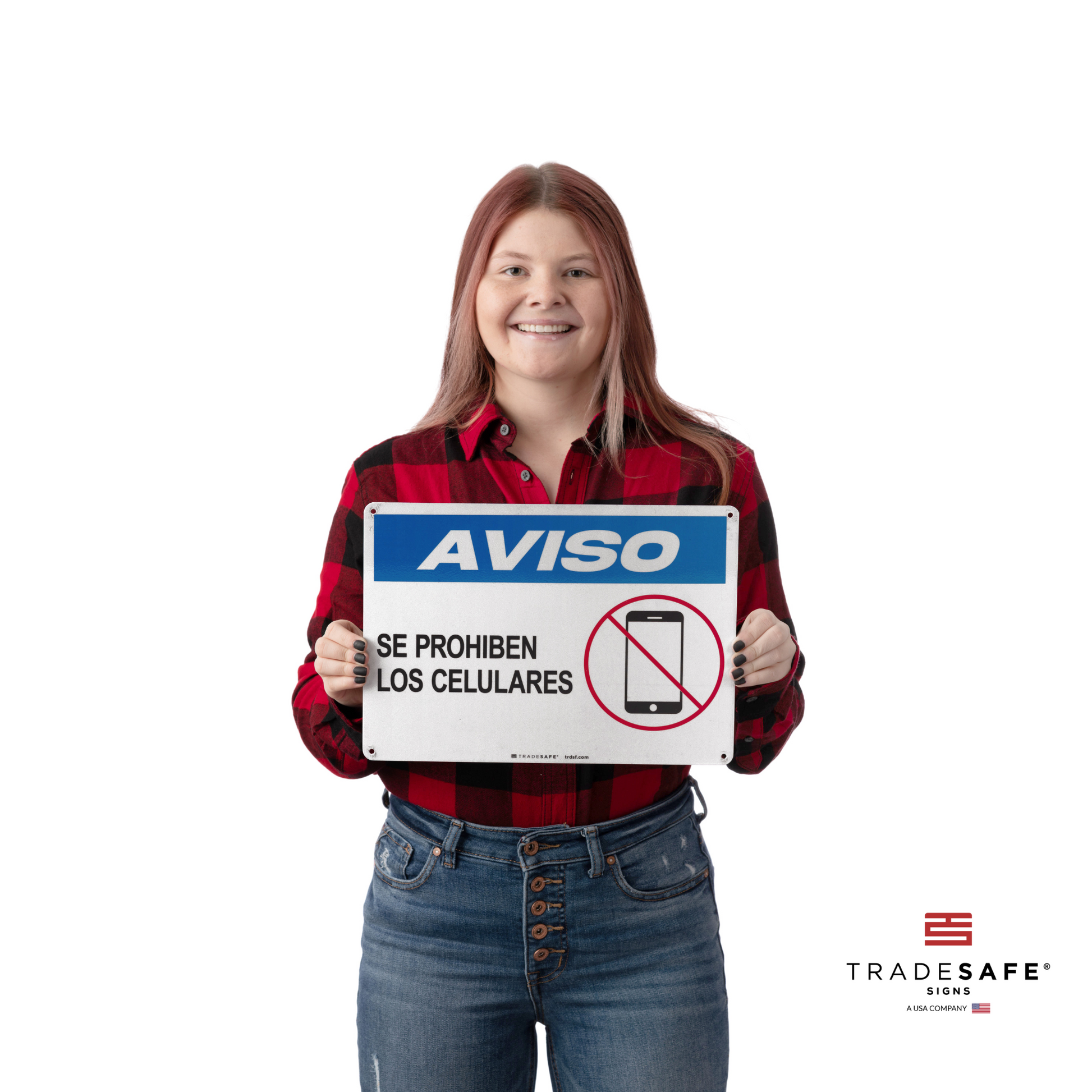 a person holding "aviso se prohiben los celulares" sign