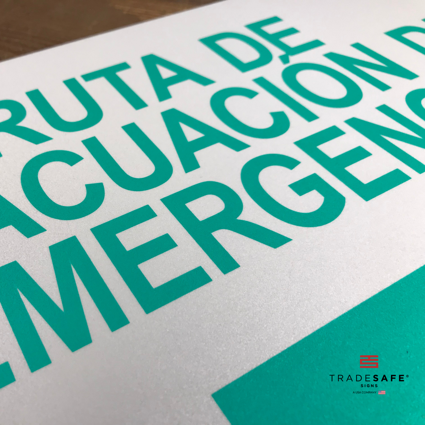 vibrant and highly visible "ruta de evacuación de emergencia" sign with right arrow