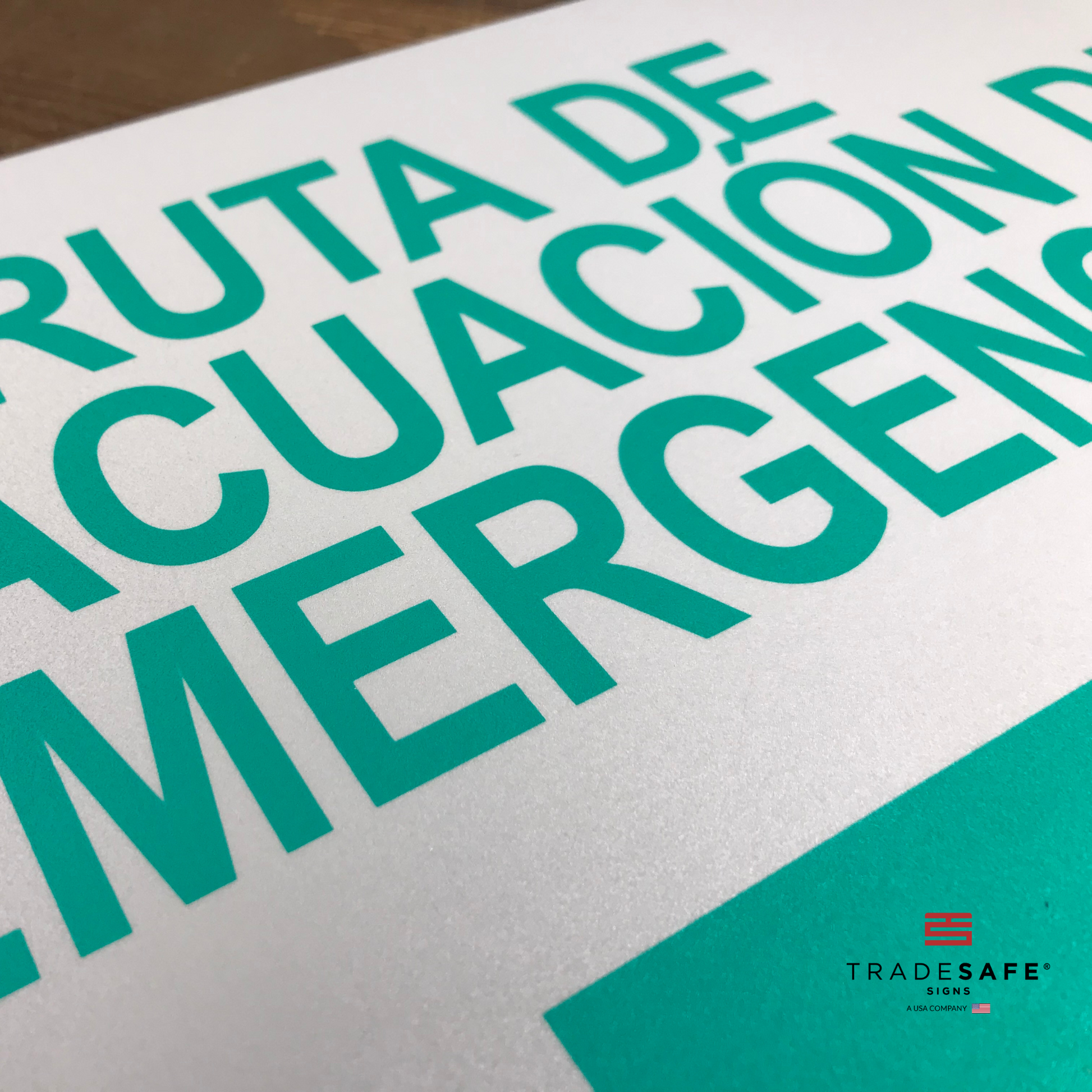 vibrant and highly visible "ruta de evacuación de emergencia" sign with right arrow