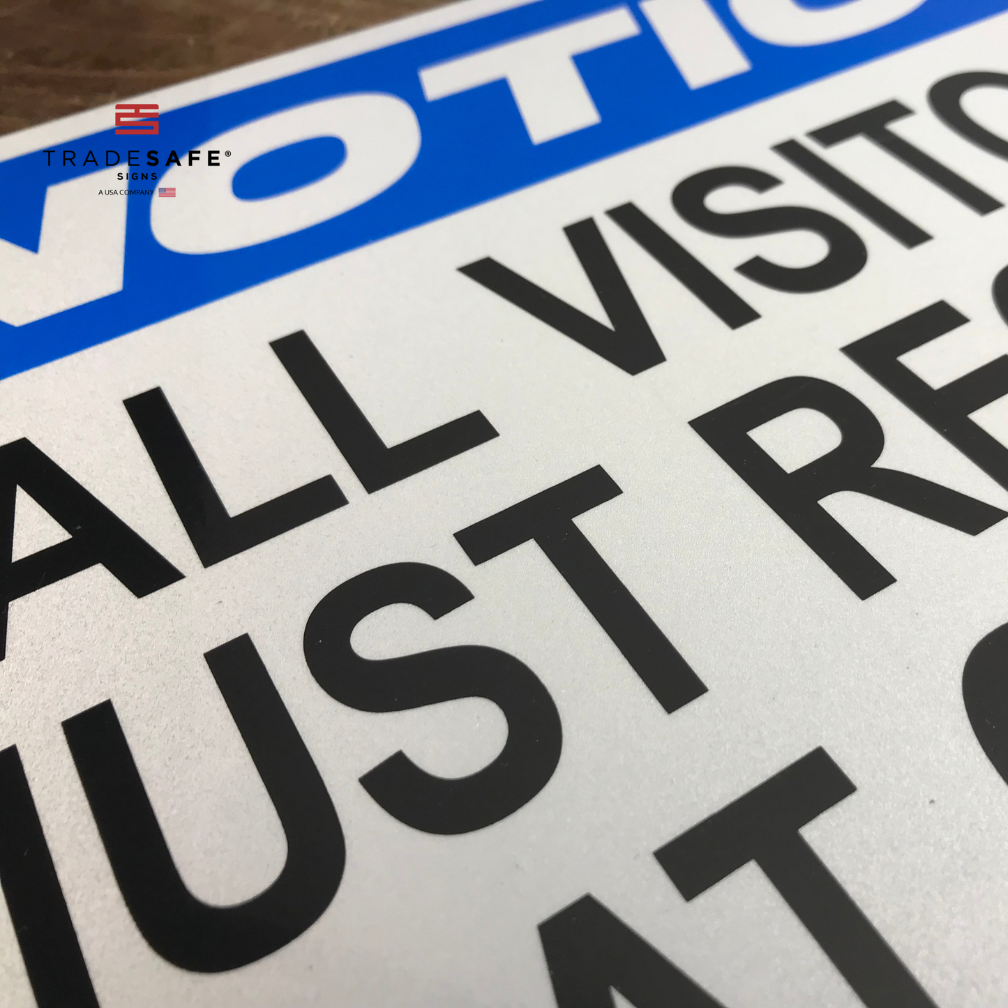 close-up of notice sign with the text "all visitors must register at office"