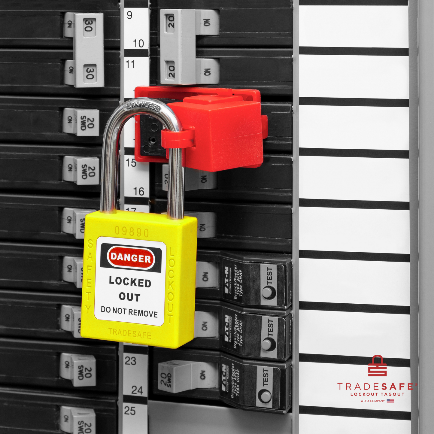 a yellow loto padlock in use along with a clamp-on circuit breaker lock